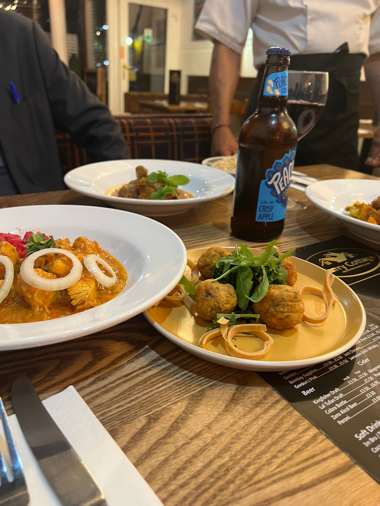 A table spread with curries and starters at Curry Cottage